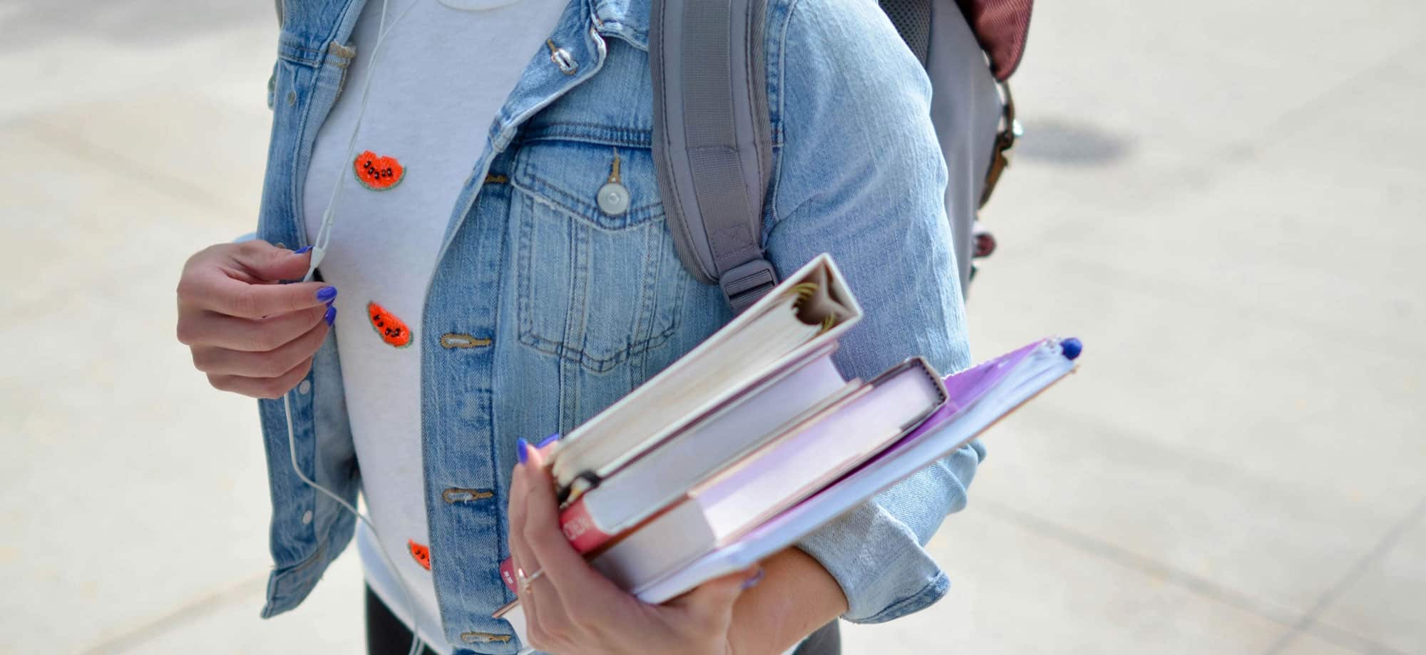Bookbag and books in had