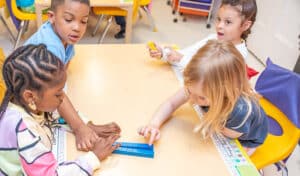 group of children works on counting blocks together
